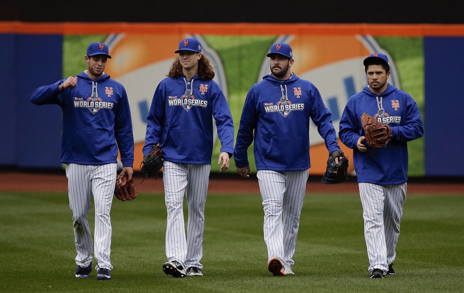 From left, New York Mets pitchers Steven Matz, Jacob deGrom and Matt Harvey and catcher Travis d'Arnaud walk off the field at the end of batting practice, Saturday, Oct. 24, 2015, in New York.  The Mets will face the Kansas City Royals in Game 1 of the World Series on Tuesday. (AP Photo/Julie Jacobson)
