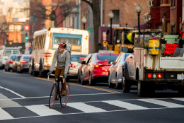 A bicyclist moves past cars stuck in traffic along Florida Avenue in the Shaw neighborhood. (AP Photo/Andrew Harnik)