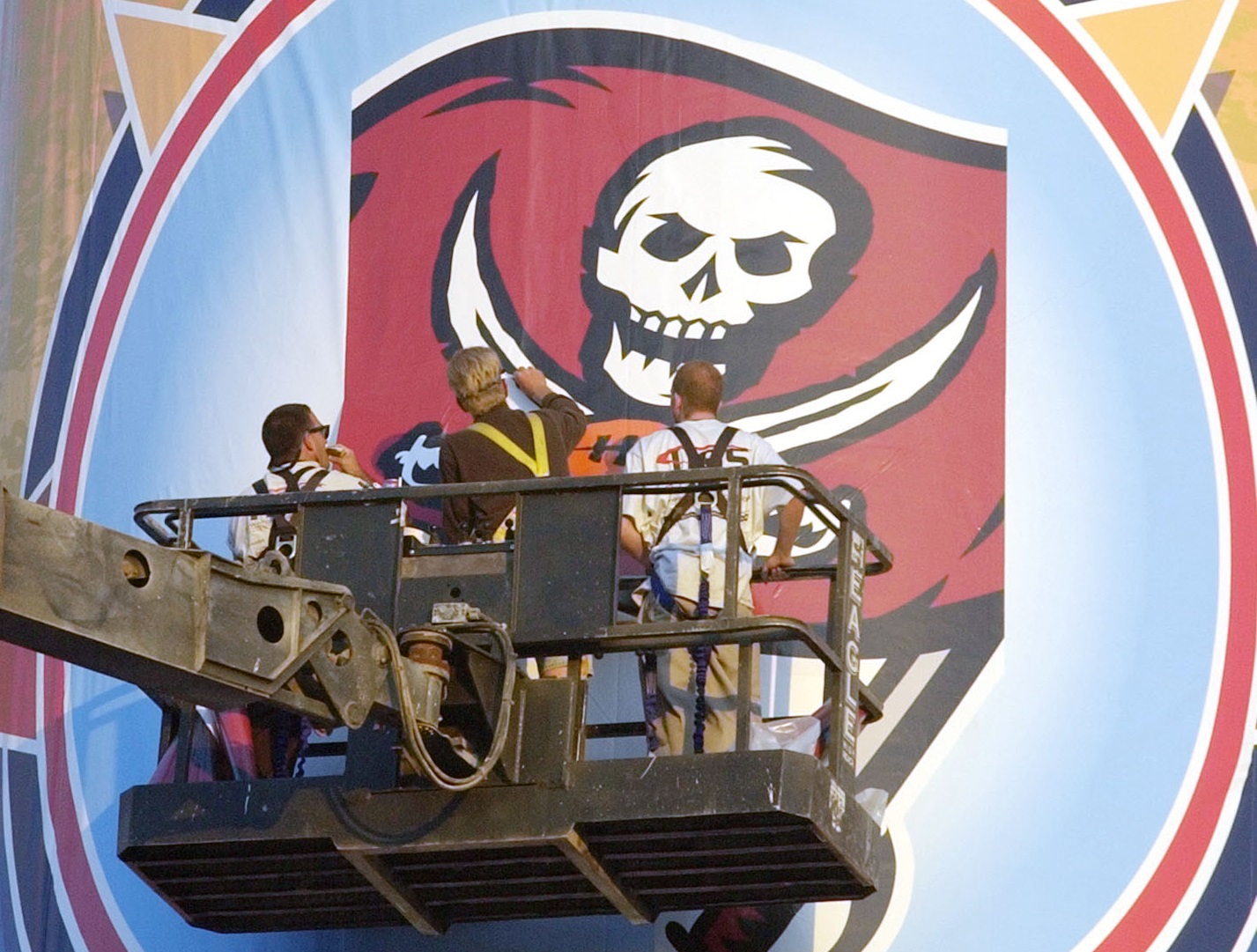 Workers put the finishing touches on the Tampa Bay Buccaneers logo at Qualcomm Stadium in San Diego, Calif. Tuesday, Jan. 21, 2003. The Bucs will face the Oakland Raiders on Sunday, Jan. 26, 2003, in Super Bowl XXXVII. (AP Photo/David J. Phillip)