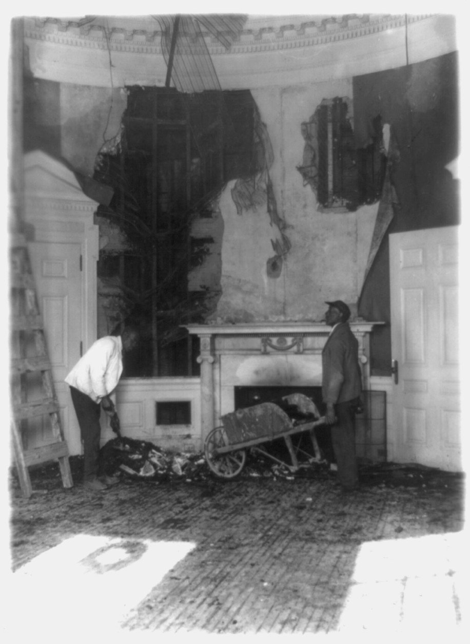 Workers collect fire-damaged debris from the Oval Office, December 26, 1929. (PHOTO: Library of Congress)