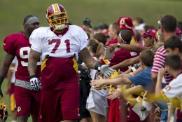 Washington Redskins offensive lineman Trent Williams, right, and linebacker Brian Orakpo arrive for the teams NFL football training camp practice on Monday, July 30, 2012 in Ashburn, Va.  (AP Photo/Evan Vucci)