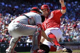Washington Nationals' Ryan Zimmerman, right, slides safely into home as Philadelphia Phillies catcher Humberto Quintero cannot handle the throw during the seventh inning of a baseball game at Nationals Park, Sunday, May 26, 2013, in Washington. The Nationals won 6-1. (AP Photo/Alex Brandon)