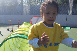 Four year-old Joshua Brown playing and enjoying the new adaptive sports court in Potomac, MD (WTOP/Kathy Stewart)