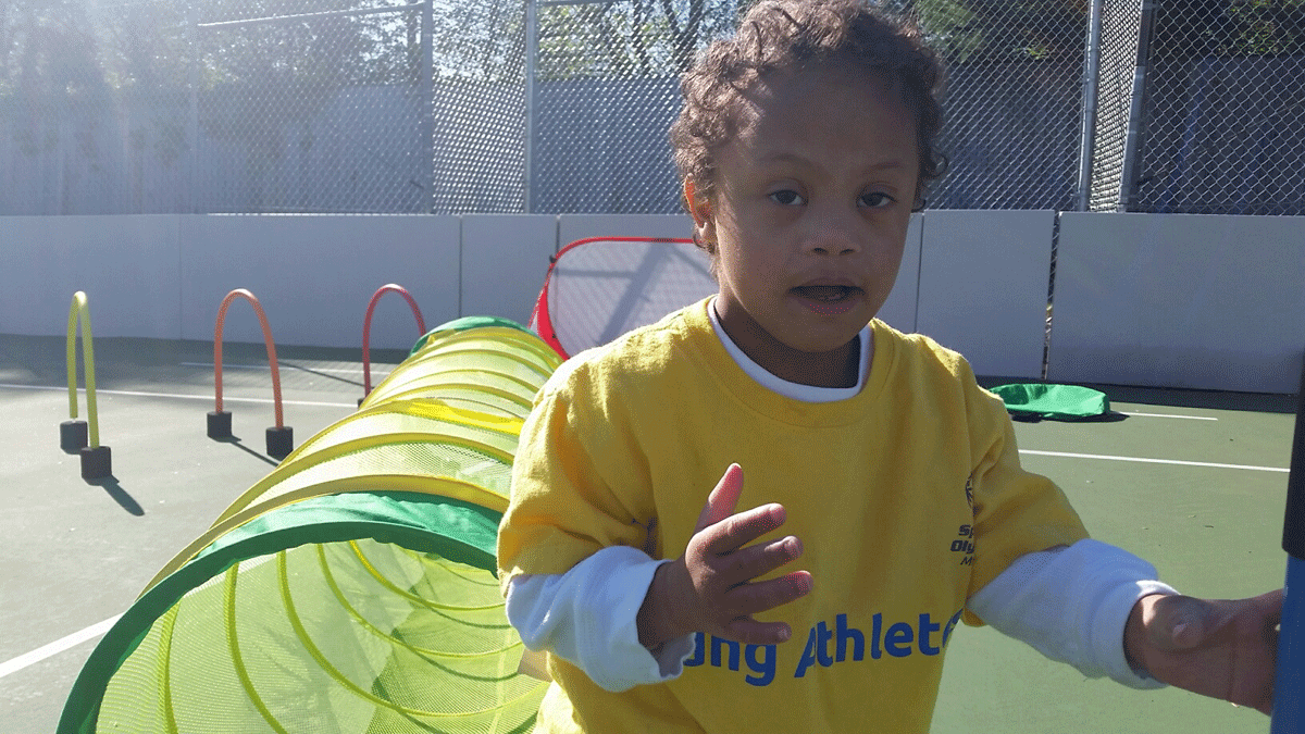 Four year-old Joshua Brown playing and enjoying the new adaptive sports court in Potomac, MD (WTOP/Kathy Stewart)