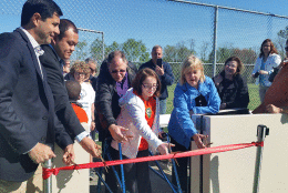 Ribbon cutting for new sports court. In middle, Mary Cassell, on the right, Montgomery County Council President Nancy Floreen  and to the right, councilmember Sidney Katz (WTOP/Kathy Stewart)