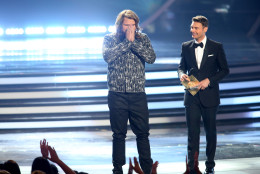 Caleb Johnson reacts on stage after he is announced winner at the American Idol XIII finale at the Nokia Theatre at L.A. Live on Wednesday, May 21, 2014, in Los Angeles.  Looking on from right, Ryan Seacrest. (Photo by Paul A. Hebert/Invision/AP)
