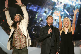 "American Idol" finalists Bo Bice, left, and Carrie Underwood, right, wave to the crowd from the stage with the show's host Ryan Seacrest after their final performance at the Kodak Theater in Los Angeles, Tuesday, May 24, 2005. People will vote on tonight's performance and the results will be announced on Wednesday. (AP Photo/Kevork Djansezian)