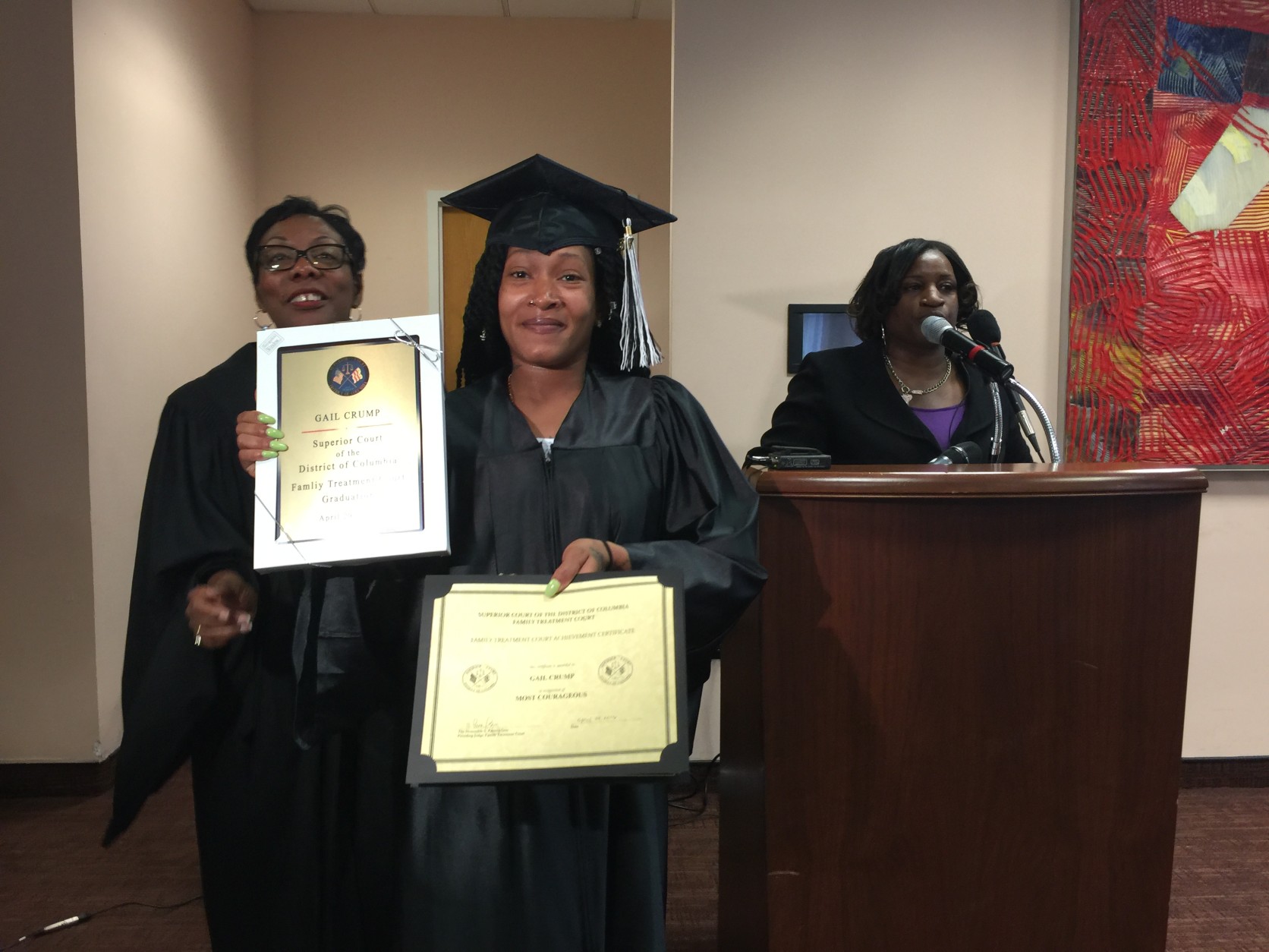 Gail Crump received the "Most Courageous" award. "Despite her initial reluctance, she took a chance on herself and as a result of that she's here graduating today. We're so proud of her," said Dr. Sariah Beatty, Coordinator, Family Treatment Court on right. Pictured also with Judge Pam Gray. (WTOP/Kristi King)