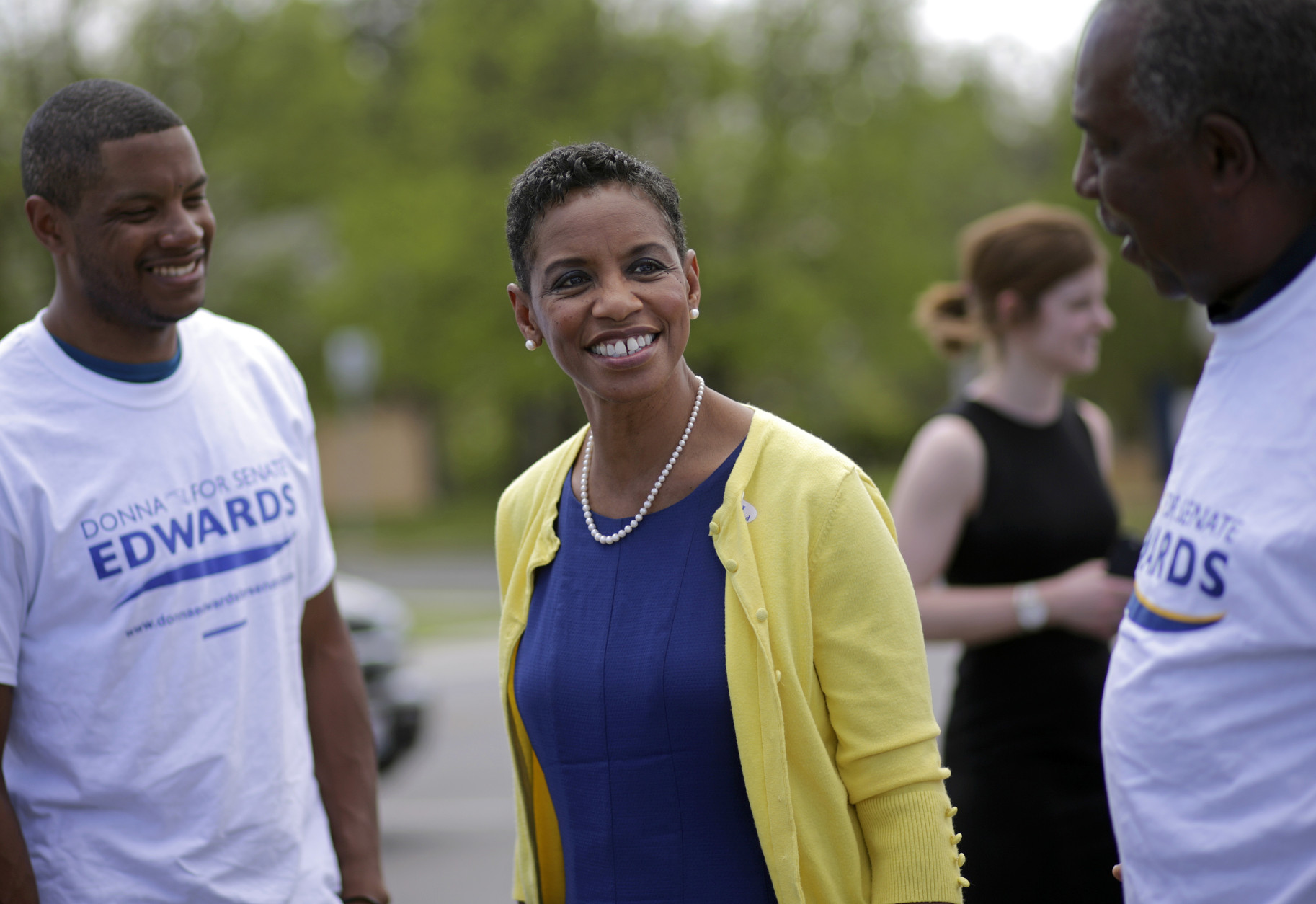 Democratic U.S. Senate candidate, Rep. Donna Edwards, D-Md., center, and her son Jared, back left, greet volunteers outside a polling place at Winfield Elementary School in Windsor Mill, Md., Tuesday, April 26, 2016. Edwards is running against Rep. Chris Van Hollen, D-Md., in the Democratic primary for U.S. Senate. (AP Photo/Patrick Semansky)