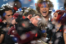 Kelly Clarkson, 20, of Burleson, Texas, center, is surrounded by other finalists, including runner up Justin Guarini, right rear, after winning in the final episode of Fox's television competition "American Idol," in Los Angeles, Wednesday, Sept. 4, 2002. The winner earns a recording contract, and will release a CD single later this month and a full album in November. (AP Photo/Lucy Nicholson)