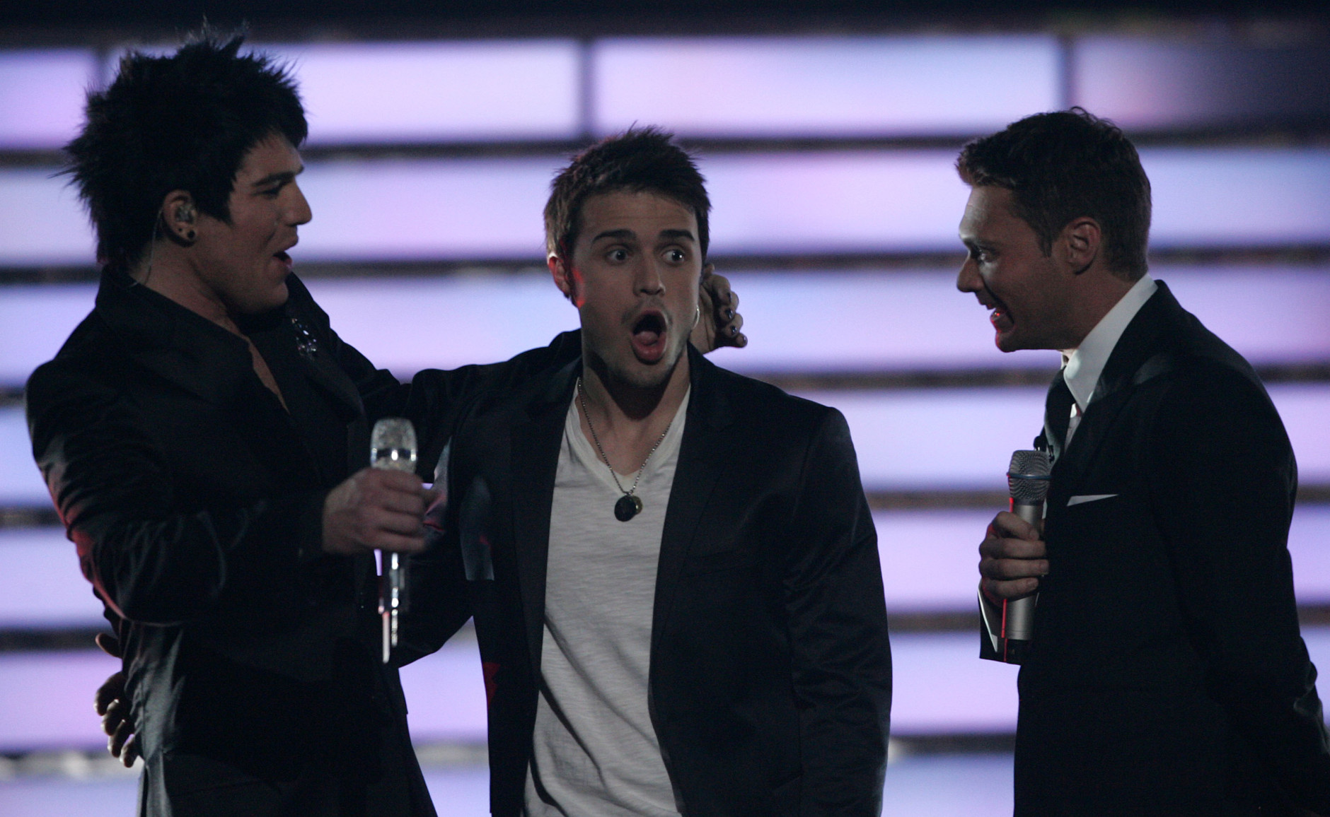 Kris Allen, center, reacts as Ryan Seacrest, right, announces the winner of American Idol on Wednesday May 20, 2009, in Los Angeles. At left, is Adam Lambert. (Evans Vestal Ward/AP Images for Fox)