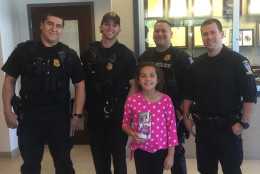 9-year-old Elizabeth Barry, a Girl Scout, dropped off cases of cookies to two Montgomery County police stations on Sunday, along with thank you letters to officers. (Courtesy Katherine Barry)