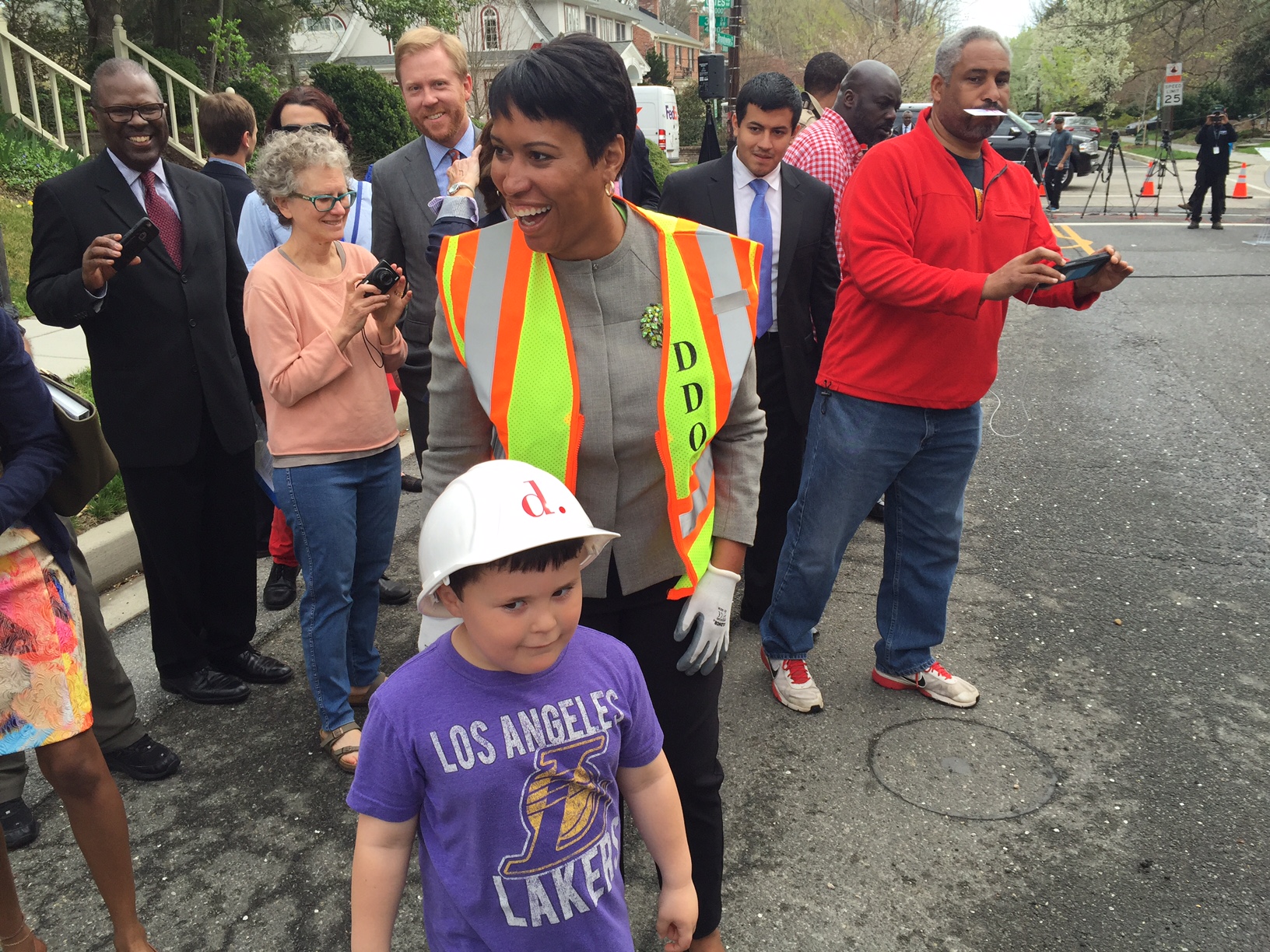 When asked if he wanted to help the mayor fill a pothole, the neighborhood kid told her he didn't know how. (WTOP/Megan Cloherty)