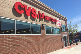 A "now open" sign is seen on the CVS Pharmacy that was destroyed during the Baltimore riots in April 2015. (WTOP/Mike Murillo)