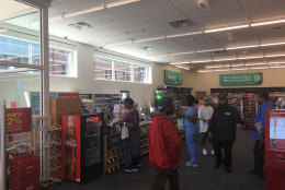 Customers walk around the CVS Pharmacy in Baltimore that was destroyed during the riots in April 2015. (WTOP/Mike Murillo)