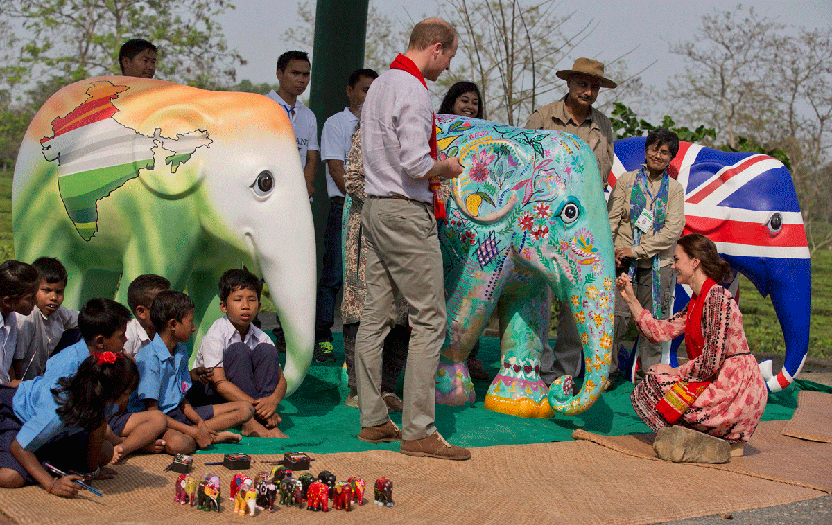 Britain's Prince William and his wife, Kate, the Duchess of Cambridge give finishing touch of paint on a statue of elephant at the Centre for Wildlife Rehabilitation and Conservation (CWRC) at Panbari reserve forest in Kaziranga, east of Gauhati, northeastern Assam state, India, Wednesday, April 13, 2016. The royal couple spent several hours at the Kaziranga National Park in hopes of drawing attention to the plight of endangered animals, including the park's 2,200-population of a rare, one-horned rhinos. (AP Photo/Anupam Nath)