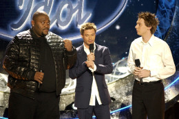 Ruben Studdard from Birmingham, Ala., left, jokingly shows his fist to fellow finalist Clay Aiken of Raleigh, N.C., while host Ryan Seacrest watches before the contestants' final performances on "American Idol," Tuesday, May 20, 2003, in Universal City, Calif. (AP Photo/Kevork Djansezian)