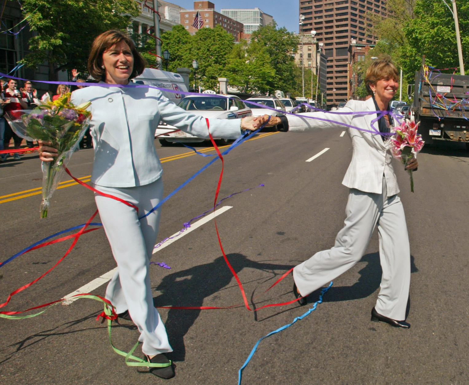 ** FILE ** Julie Goodridge, left, and her spouse Hillary Goodridge cross the street in front of the State House in Boston while leaving the Unitarian Universalist church after being married in this Monday, May 17, 2004 file photo.  According to a local political consultant, the couple whose lawsuit ultimately led to legal same-sex marriage in Massachusetts have announced they have separated. (AP Photo/Winslow Townson)