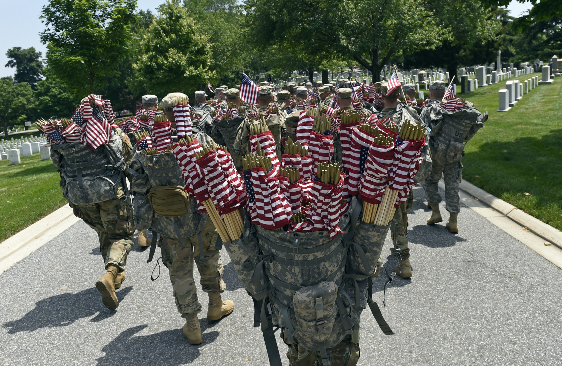 Members of the Old Guard prepare to place flags in front of every headstone at Arlington National Cemetery in Arlington, Va., Thursday, May 26, 2016. Soldiers were to place nearly a quarter of a million U.S. flags at the cemetery as part of a Memorial Day tradition. (AP Photo/Susan Walsh)