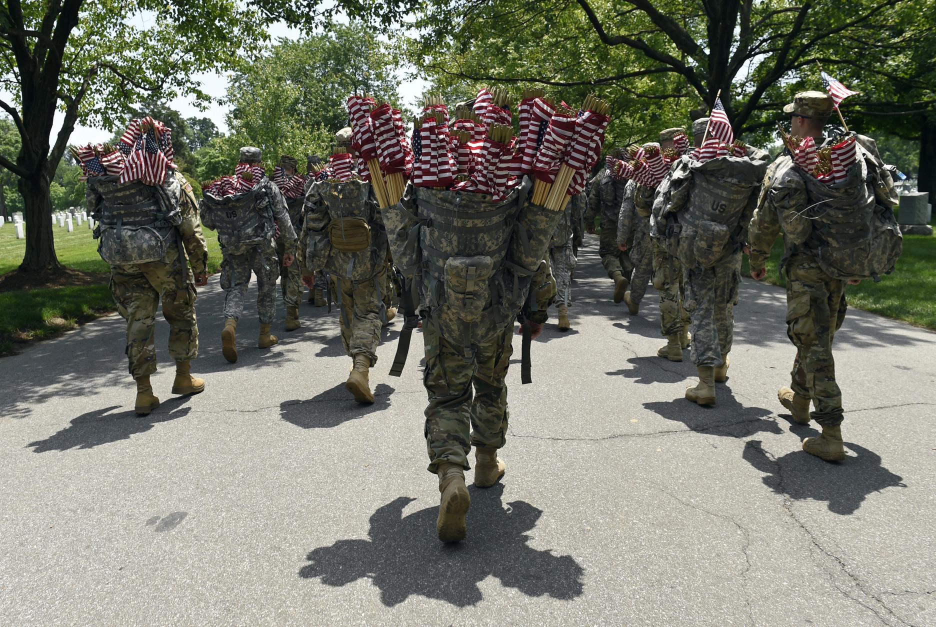 Members of the Old Guard prepare to place flags in front of every headstone at Arlington National Cemetery in Arlington, Va., Thursday, May 26, 2016. Soldiers were to place nearly a quarter of a million U.S. flags at the cemetery as part of a Memorial Day tradition. (AP Photo/Susan Walsh)
