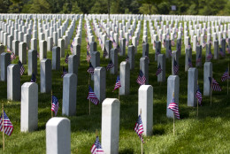 Members of the Old Guard, placed flags in front of every headstone at Arlington National Cemetery in Arlington, Va., Thursday, May 26, 2016. Soldiers were to place nearly a quarter of a million American flags at the cemetery as part of a Memorial Day tradition. (AP Photo/Jose Luis Magana)