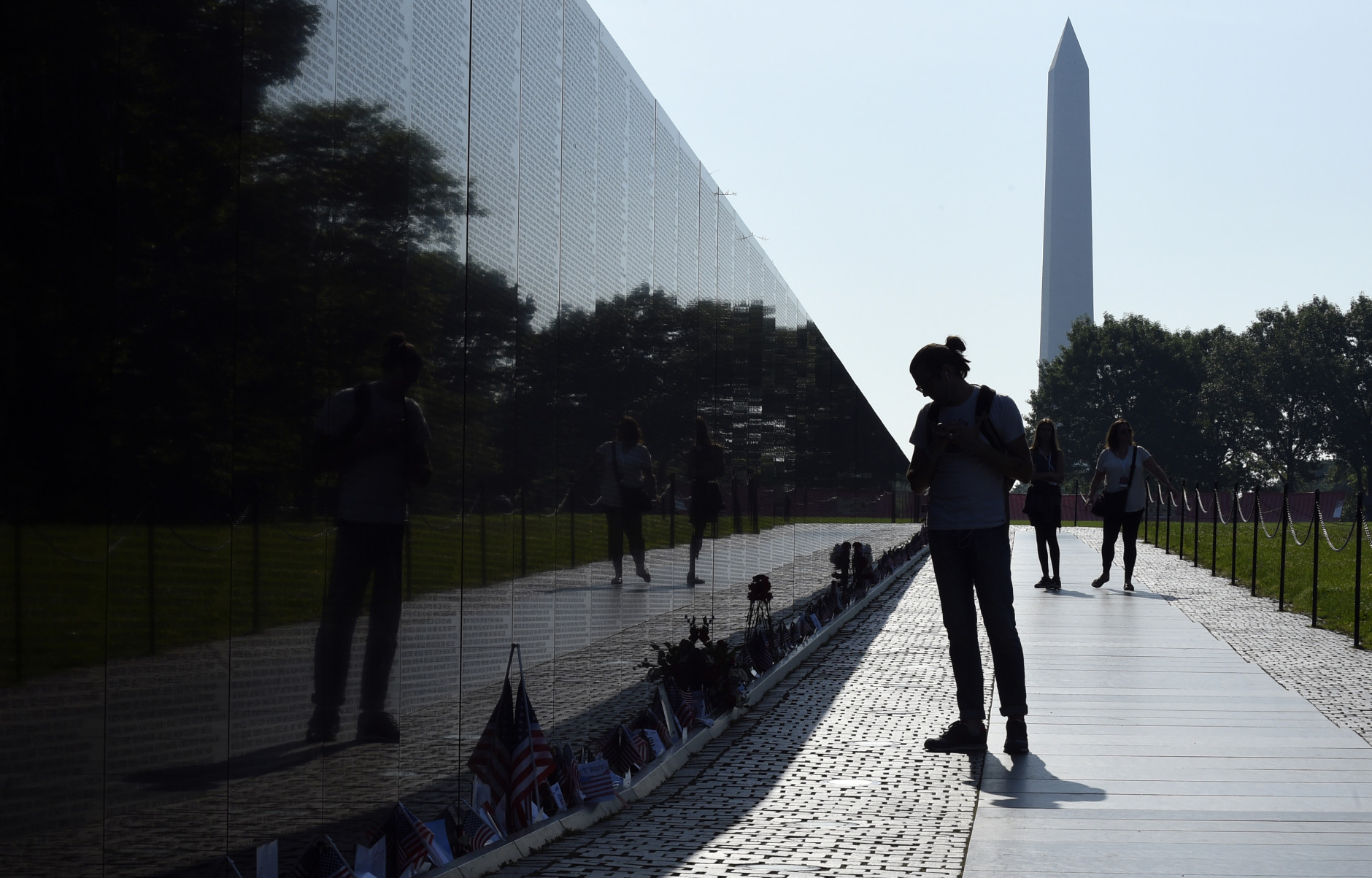 With the Washington Monument in the background, people visit the Vietnam Memorial in Washington, Friday, May 27, 2016,on the start of the Memorial Day weekend. (AP Photo/Susan Walsh)