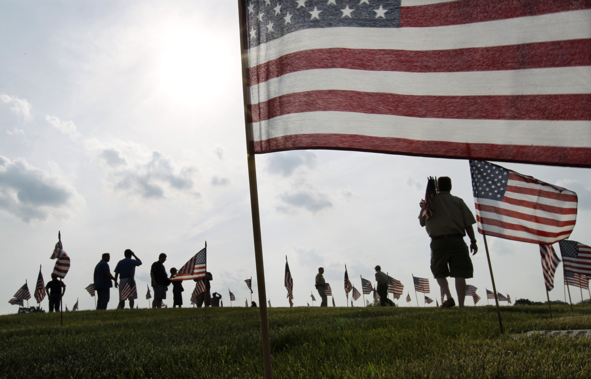 Throngs of scouts place thousands of flags on veteran's graves at Brig. Gen. William C. Doyle Veterans Memorial Cemetery in honor of Memorial Day, Friday, May 27, 2016, in Wrightstown N.J. (AP Photo/Mel Evans)