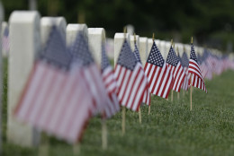 American flags fly next to veterans' graves ahead of Memorial Day at the Crown Hill National Cemetery, Saturday, May 28, 2016, in Indianapolis. (AP Photo/Darron Cummings)