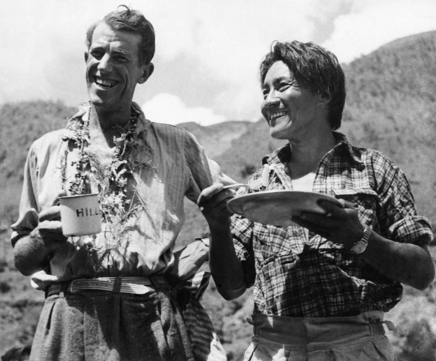Edmund Hillary and Sherpa Tenzing Norgay smile as they breakfast in Kathmandu, Nepal after a 170 mile trek from their conquest of Mount Everest on June 20, 1953. (AP Photo)