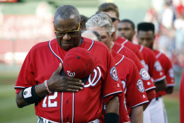 Washington Nationals manager Dusty Baker (12) and the other members of his team observe a moment of silence for Memorial Day, before a baseball game against the St. Louis Cardinals at Nationals Park, Saturday, May 28, 2016, in Washington. (AP Photo/Alex Brandon)
