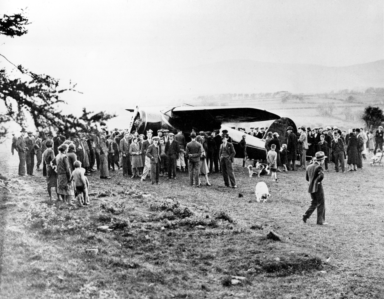 People surround Amelia Earhart's single-engine Lockheed Vega plane after she landed in an open field near Londonderry, northern Ireland, on May 21, 1932.  Earhart began her solo nonstop transatlantic flight on May 20 from Newfoundland, Canada.  (AP Photo)