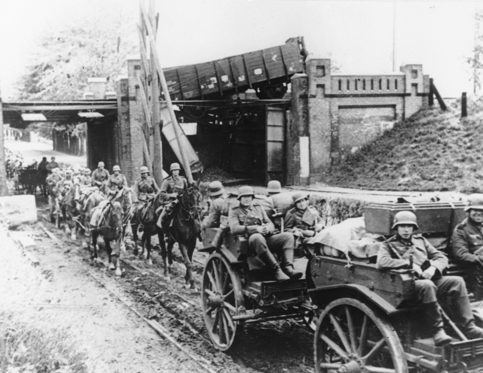 A German field artillery detachment passes under a destroyed bridge at an unknown location in the Netherlands, on May 21, 1940, as German troops invade the Low Countries during World War II. (AP Photo) (AP Photo)