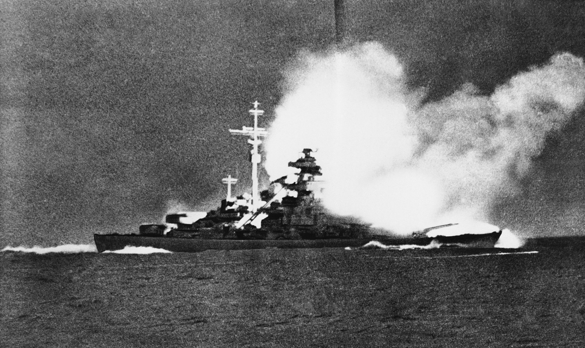 A direct hit blasts the 5,000-ton German battleship Bismarck shortly before it sank in the Atlantic 400 miles West of Brest, France, following a 1,750 mile chase from Bergen, Norway, by air and sea units of the British Navy. This picture, which has just become available, was taken by Yeoman 1/c Fritz Dungert aboard the former German Cruiser Prinz Eugen which is now at Philadelphia prepared  to sail to the South Pacific where it will be one of the targets in the atomic bomb tests next May. Dungert says the picture was taken May 27, 1941, the day the Bismarck went down. (AP Photo)