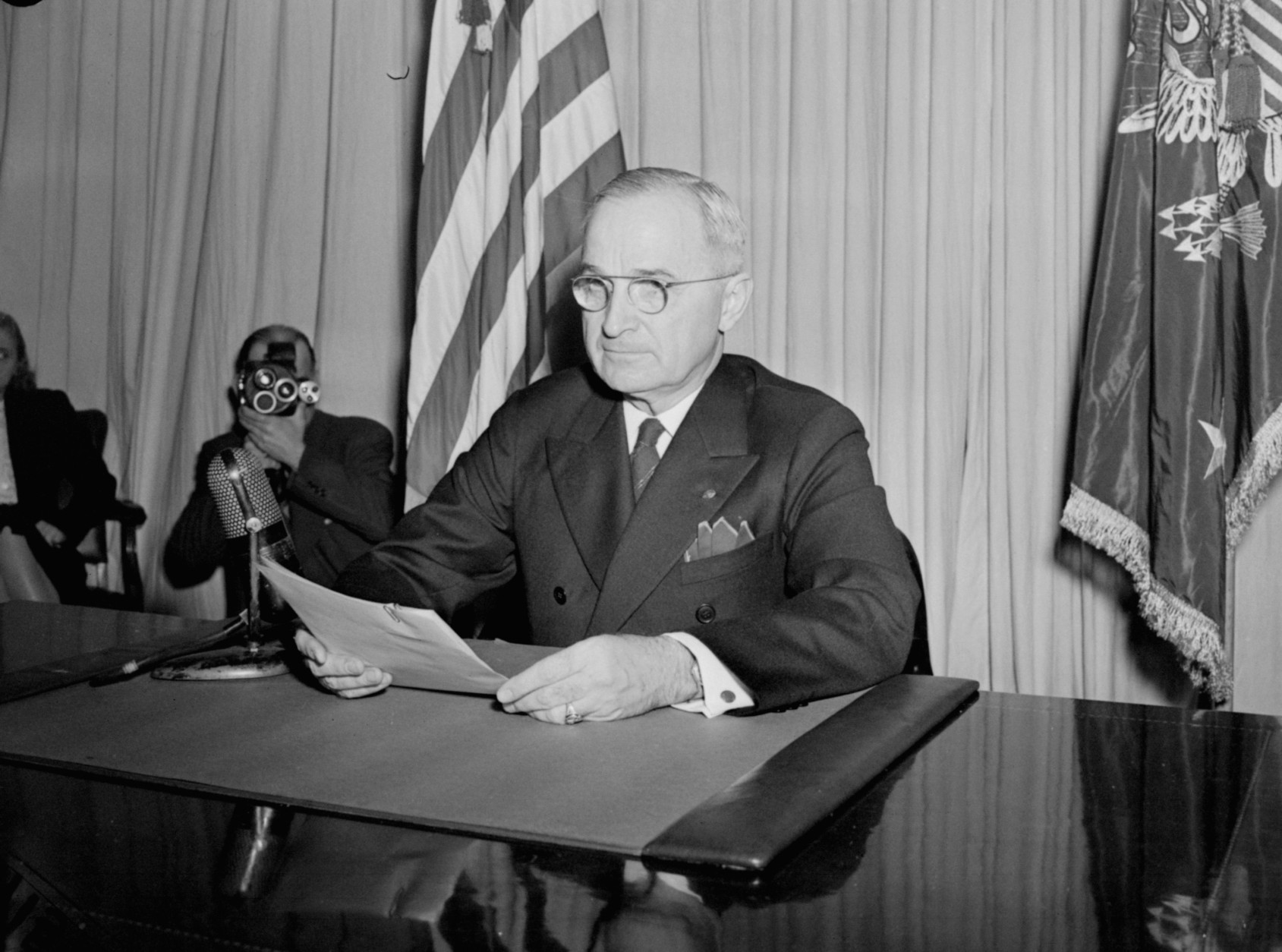President Truman sits before a microphone, holding his speech, at the White House, Washington, DC, May 8, 1945, after he had finished reading his announcement to the nation that Allied Armies have won unconditional surrender from the German forces on all fronts. (AP Photo/stf)