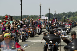 Participants in the Rolling Thunder annual motorcycle rally ride past Arlington memorial bridge during the parade ahead of Memorial Day in Washington, Sunday, May 24, 2015. (AP Photo/Jose Luis Magana)