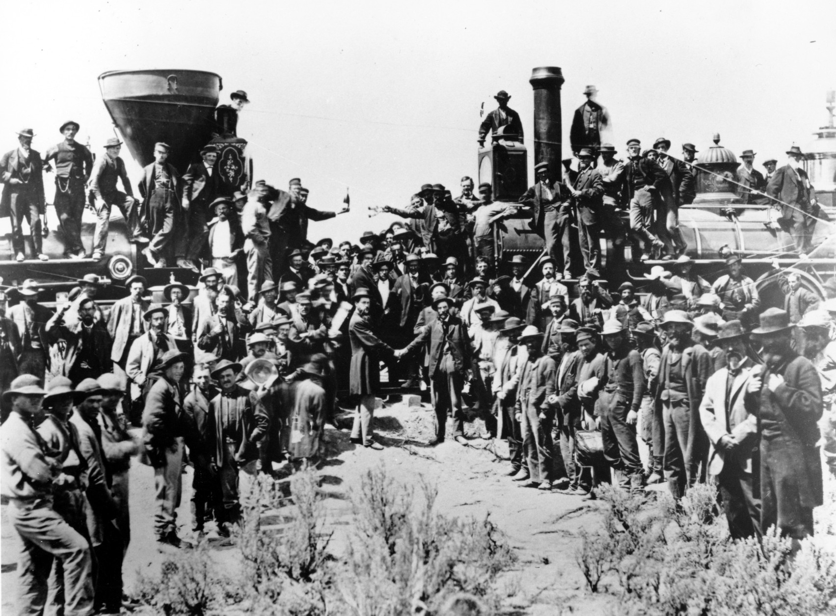 Railroad officials and employees celebrate the completion of the first railroad transcontinental link in Prementory, Utah on May 10, 1869. The Union Pacific's Locomotive No. 119, right, and Central Pacific's Jupiter edged forward over the golden spike that marked the joining of the nation by rail. (AP Photo/Union Pacific/Andrew Russell)