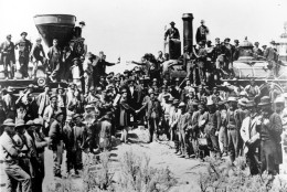 Railroad officials and employees celebrate the completion of the first railroad transcontinental link in Prementory, Utah on May 10, 1869. The Union Pacific's Locomotive No. 119, right, and Central Pacific's Jupiter edged forward over the golden spike that marked the joining of the nation by rail. (AP Photo/Union Pacific/Andrew Russell)