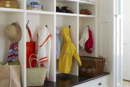 In this photo provided by Better Homes &amp; Gardens, an unused space off the kitchen or basement entrance can be turned into a mudroom that provides added value for buyers.  Retrofit readymade cabinets and benches, or splurge on custom built-ins.(AP Photo/Better Homes &amp; Gardens, Michael Partenio)