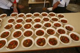 Plates of vegetable casserole made with 'wasted' produce deemed unsuitable by food stores because of the products' appearance are ready for consumption in the northern Greek city of Thessaloniki on Sunday, Nov. 9, 2014. More than 5,000 ate over 2 tons of perfectly edible produce in a 'Feeding5000' event organized by global CEO Feedback to highlight the waste of foodstuff in advanced societies. (AP Photo/Grigoris Siamidis)