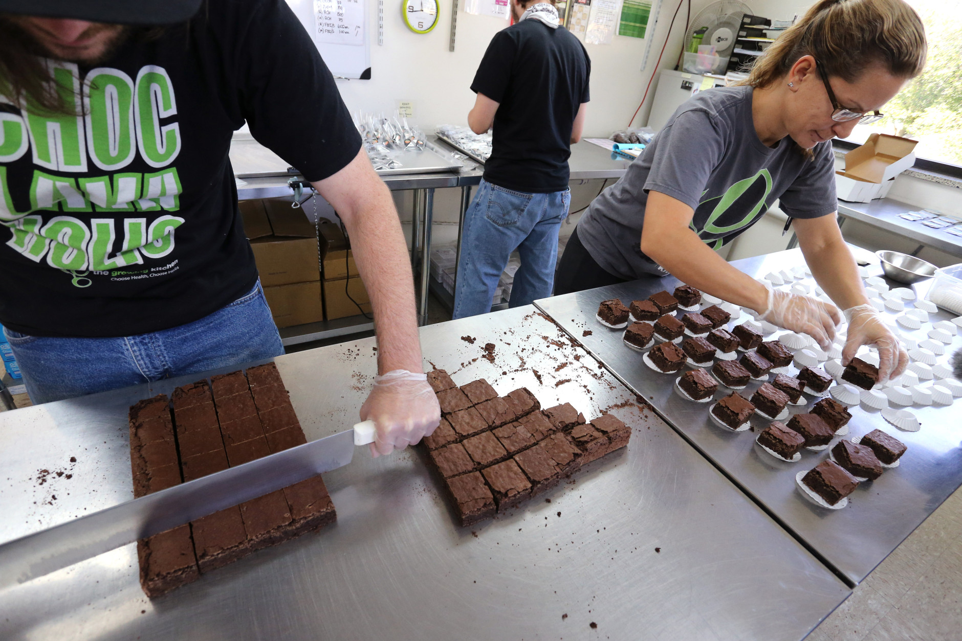 FILE - In this Sept. 26, 2014 file photo, smaller-dose pot-infused brownies are divided and packaged at The Growing Kitchen, in Boulder, Colo. Colorado health officials want to ban many edible forms of marijuana, including brownies, cookies and most candies, limiting sales of pot-infused food to lozenges and some liquids.(AP Photo/Brennan Linsley,File)