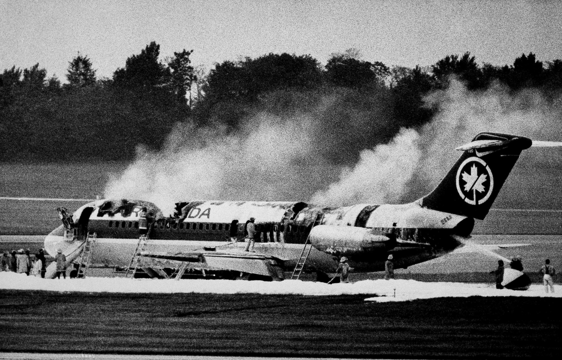 An Air Canada DC-9 smolders at the end of a runway at Greater Cincinnati Airport in Cincinnati on June 2, 1983. (AP Photo/Al Behrman)