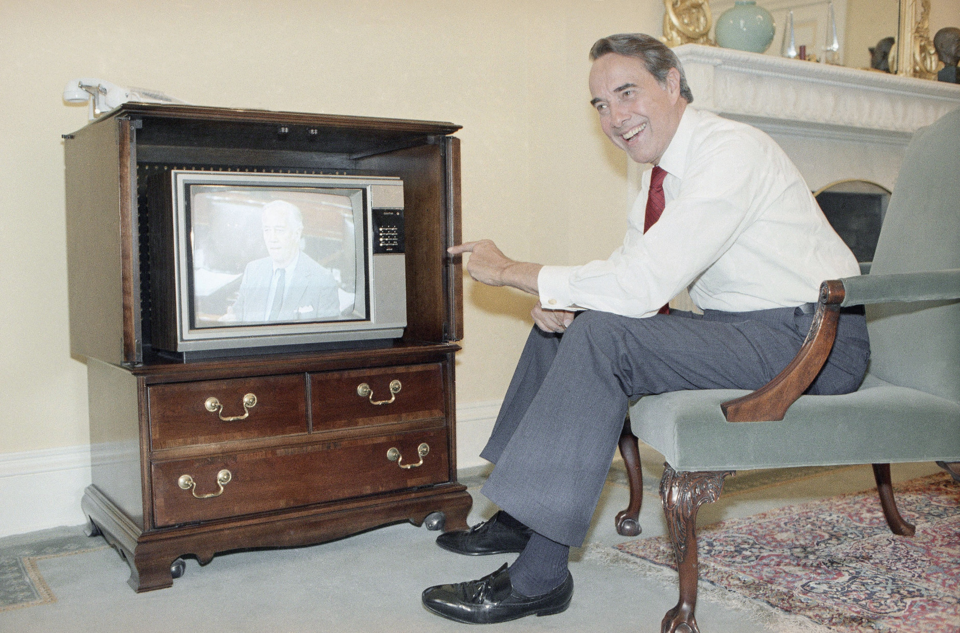 Senate Majority Leader Sen. Bob Dole of Kansas watches Sen. Charles McC. Mathias Jr. on television during a Senate floor debate, from his office on Capitol Hill, Washington, Monday, June 2, 1986. The Senate launched a six-week experiment of making its floor sessions available for live broadcast by television networks. (AP Photo/Lana Harris)