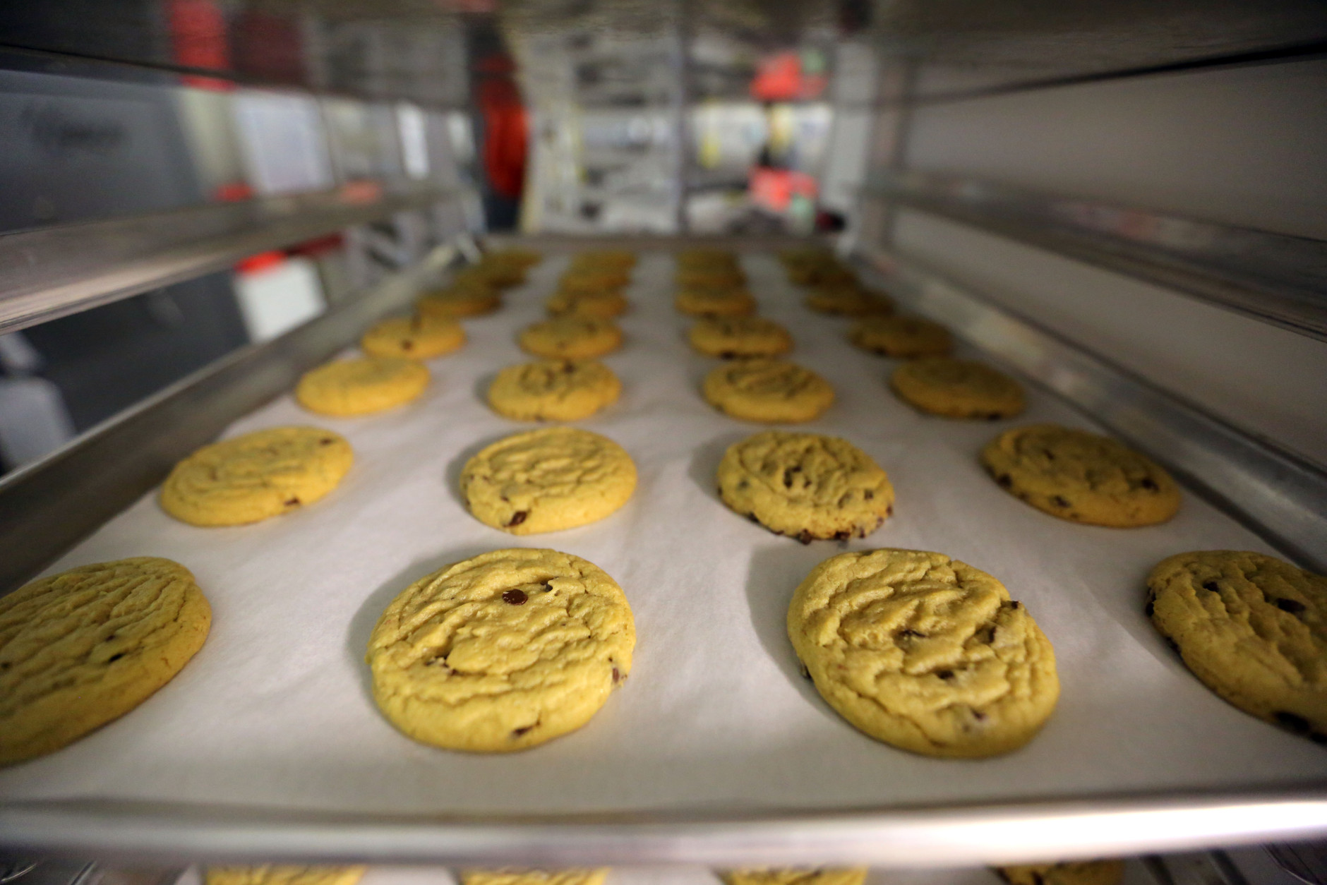 In this June 19, 2014 photo, freshly baked cannabis-infused cookies cool on a rack inside Sweet Grass Kitchen, a well-established gourmet marijuana edibles bakery which sells its confections to retail outlets, in Denver. Sweet Grass Kitchen, like other cannabis food producers in the state, is held to rigorous health inspection standards, and has received praise from inspectors, according to owner Julie Berliner. (AP Photo/Brennan Linsley)