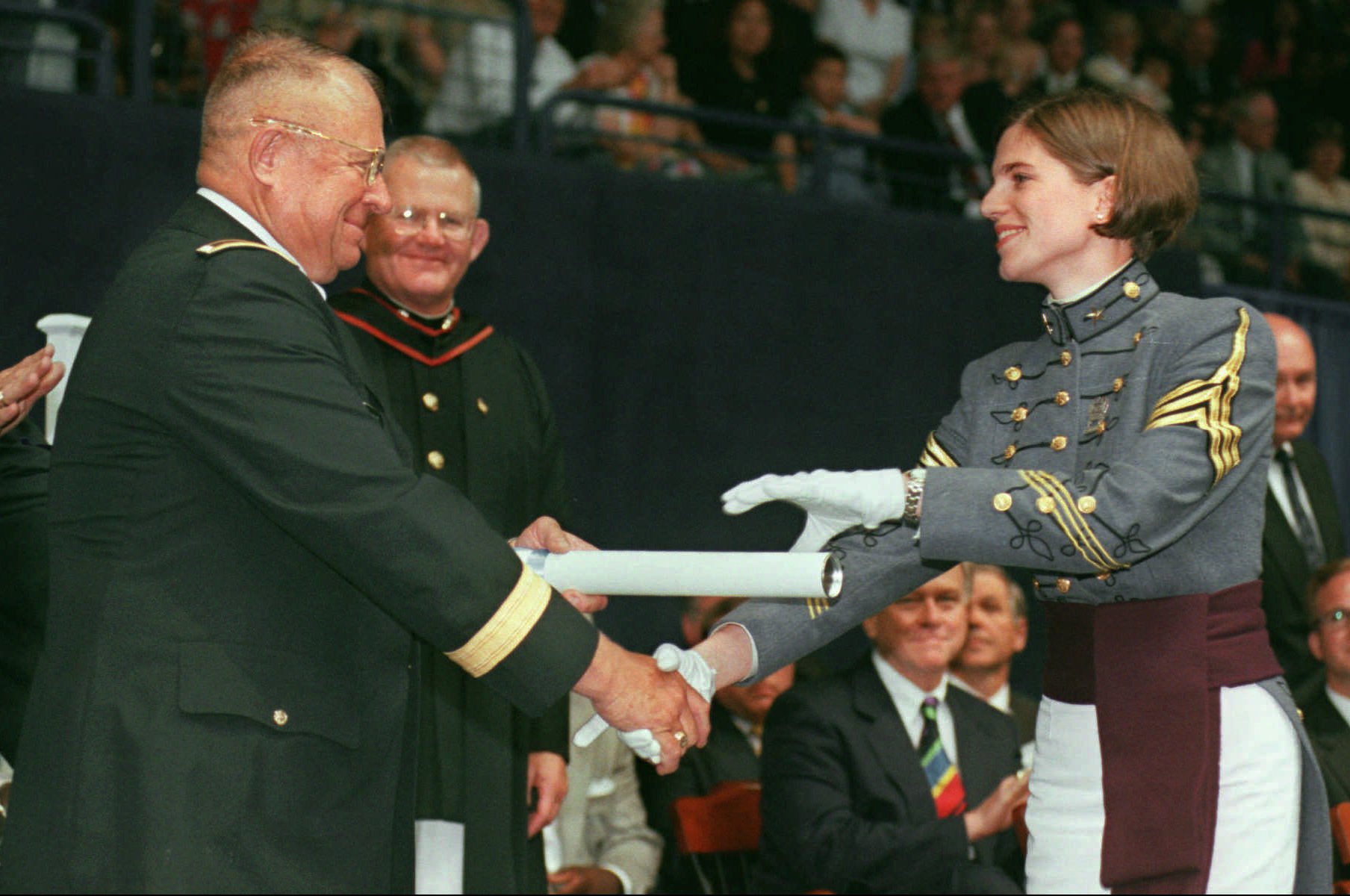 Nancy Ruth Mace, right, receives her Citadel diploma from her father Brig. Gen. James Emory Mace, the commandant of cadets and a Citadel alumnus, during The Citadel commencement Saturday, May 8, 1999.  Mace is the first female to graduate from The Citadel.  (AP Photo/Mic Smith)