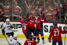 Washington Capitals T.J. Oshie (77) celebrates his second goal against Pittsburgh Penguins with teammates Nicklas Backstrom (19) and Karl Alzner (27), during the third period of Game 1 in an NHL hockey Stanley Cup Eastern Conference semifinal series Thursday, April 28, 2016, in Washington. The Capitals won 4-3 in overtime. (AP Photo/Pablo Martinez Monsivais)