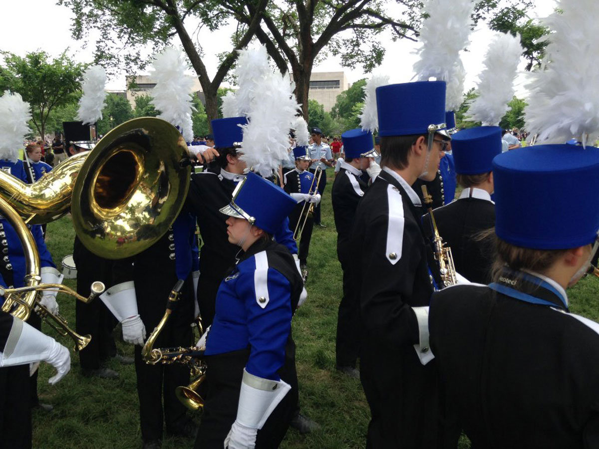 Cedaredge High School's marching band warms up for the National Memorial Day Parade on Monday. (WTOP/Megan Cloherty)