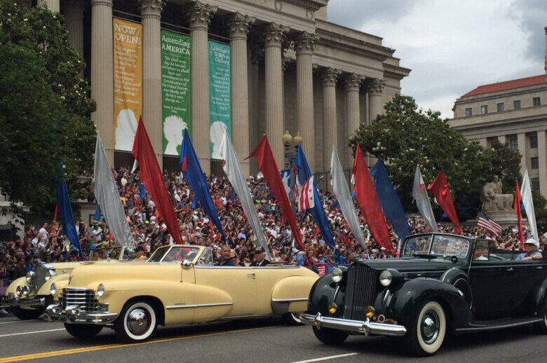 FILE — In this 2016 photo,  a parade of classic cars rolls down Constitution Avenue in honor of World War II veterans for the National Memorial Day Parade. (WTOP/Megan Cloherty, File)