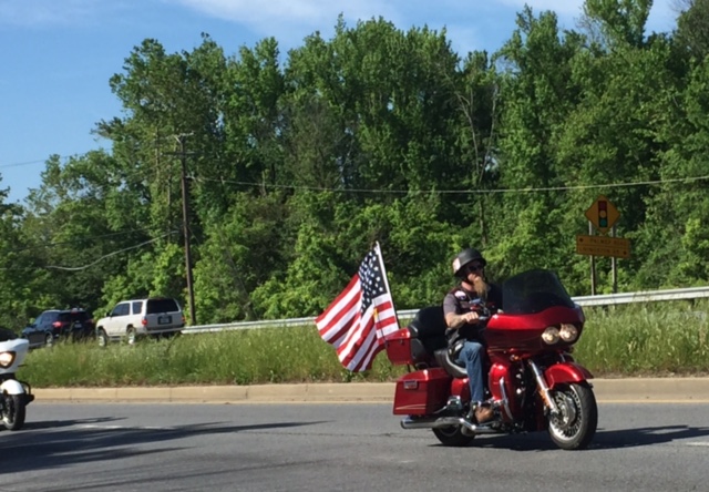 A rider displays the flag during Rolling Thunder Sunday, May 29 (Darci Marchese/WTOP)
