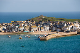 ST IVES, UNITED KINGDOM - APRIL 14:  The morning sun illuminates properties in the popular seaside resort of St Ives on April 14, 2016 in Cornwall, England. Due to the pressures that second and holiday homes are having on the town's housing market the council has asked residents to vote in a referendum on May 5 on a new town plan which includes a promise to restrict second home ownership. If the vote is passed on May 5, all new housing developments will only get permission if the homes are to be reserved by people to live in full time. People whose main residence is elsewhere will not be allowed to buy the property.  (Photo by Matt Cardy/Getty Images)