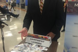 Maryland Transportation Secretary Pete Rahn with a pile of fake driver's licenses confiscated by a Howard County Police Officer. (WTOP/Dick Uliano)